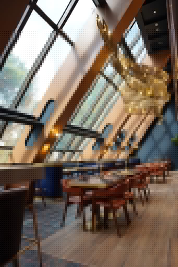 Oak and Smoke dramatic interior with slanted glass ceiling and the nine-meter smoke chandelier installation